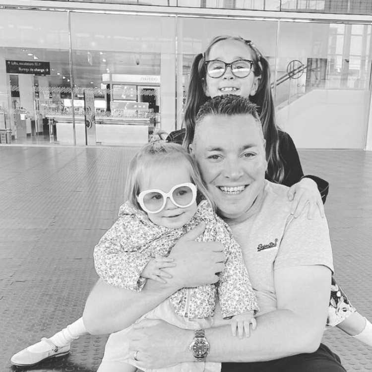 Black and white photo of man with two little girls
