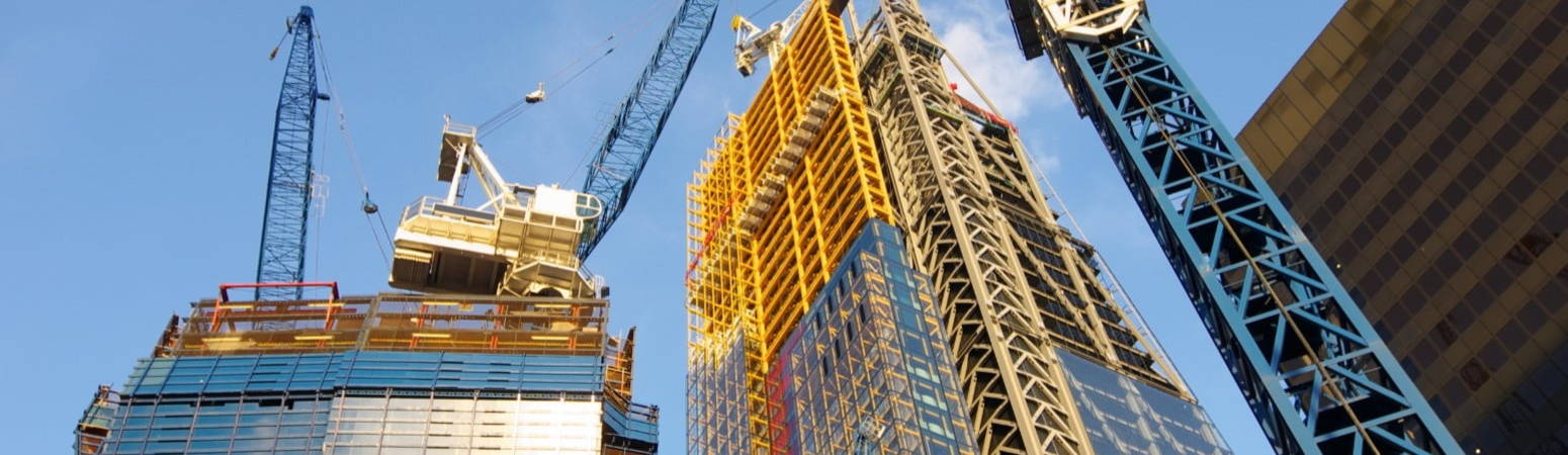 Construction site with cranes and a part built building