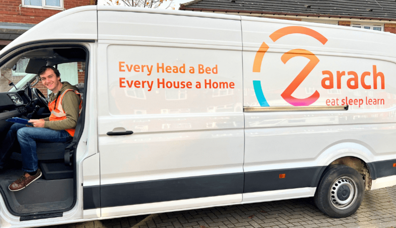 Male recruiter sat in the front of the Zarach charity van